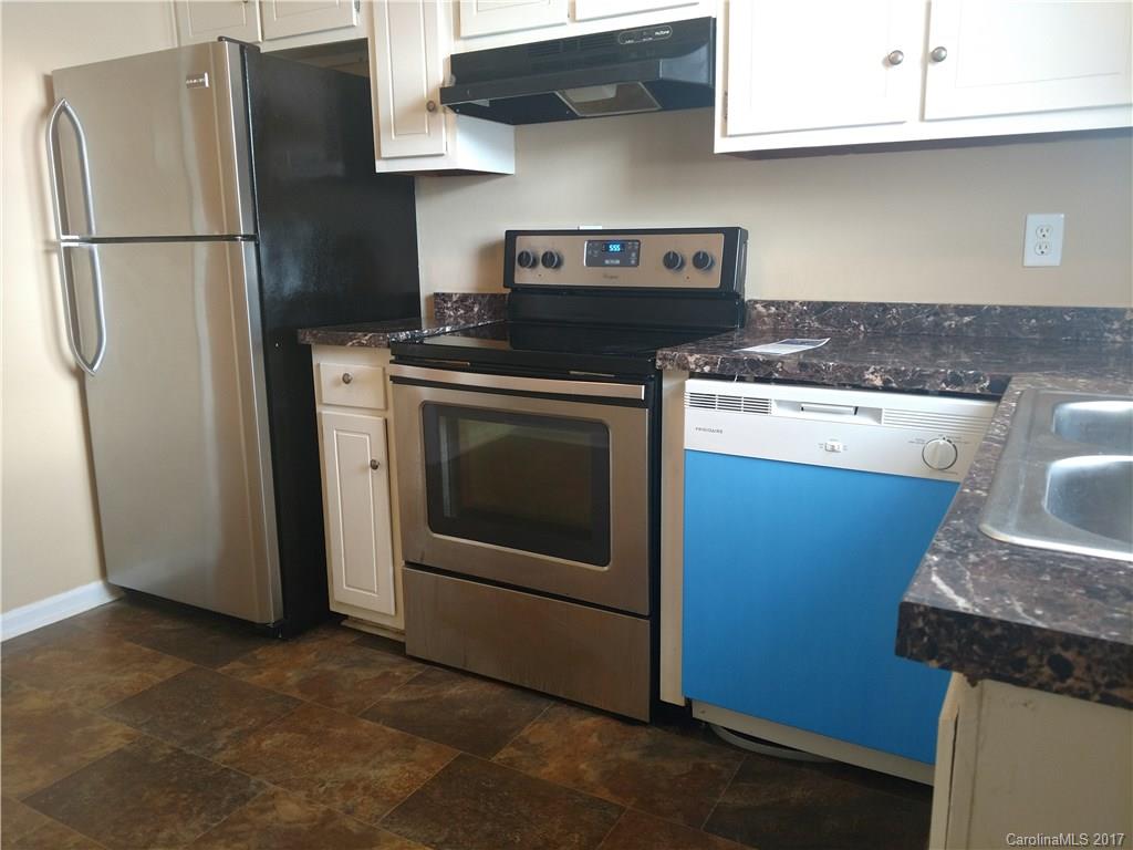 5803 Hunting Ridge Lane, Unit B Charlotte, NC 28212 - Photo 7 of 15 a kitchen with stainless steel appliances granite countertop a refrigerator stove and sink
