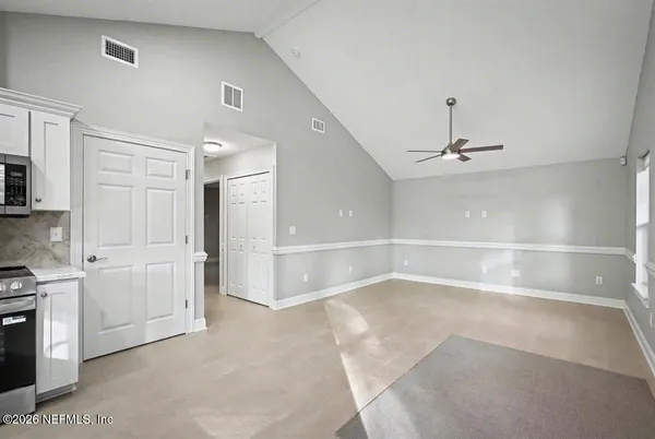 a view of a livingroom with a kitchen