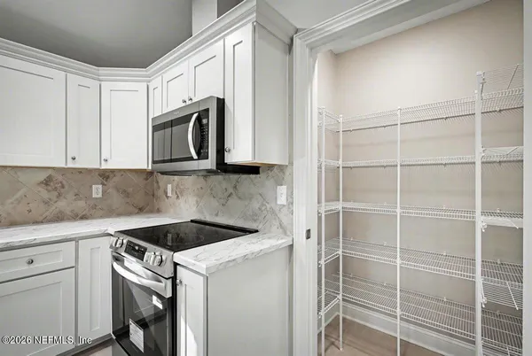 a kitchen with appliances cabinets and a counter top space