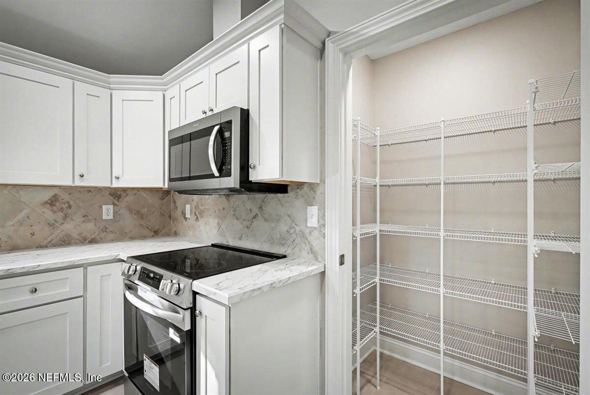 2210 Shepard Street Jacksonville, FL 32211 - Photo 16 of 28 a kitchen with appliances cabinets and a counter top space