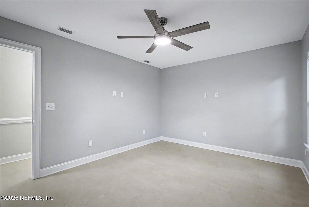 2210 Shepard Street Jacksonville, FL 32211 - Photo 22 of 29 an empty room with a ceiling fan and window