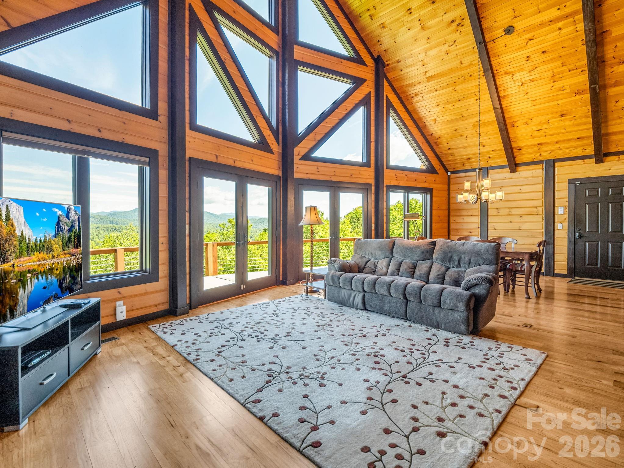 590 Boulder Ridge Lake Lure, NC 28746 - Photo 11 of 48 a bedroom with furniture and a large window