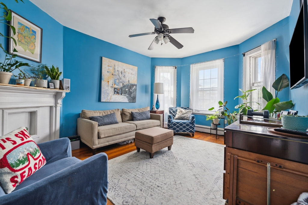 a living room with furniture a fireplace and a flat screen tv