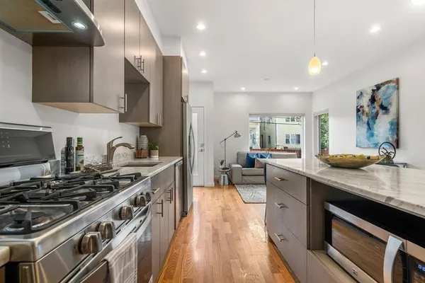 a kitchen with sink stove and cabinets