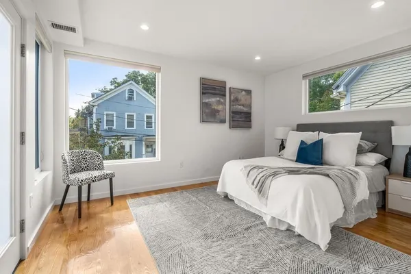 a spacious bedroom with a bed and a window