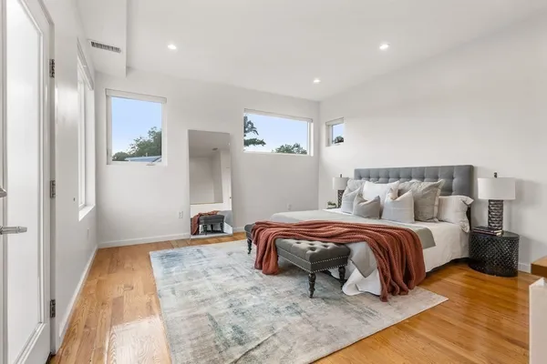 a bedroom with a bed and a mirror