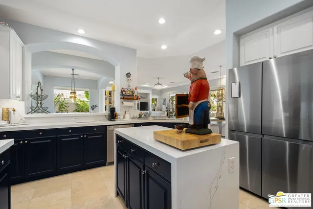 a kitchen with refrigerator a sink and cabinets