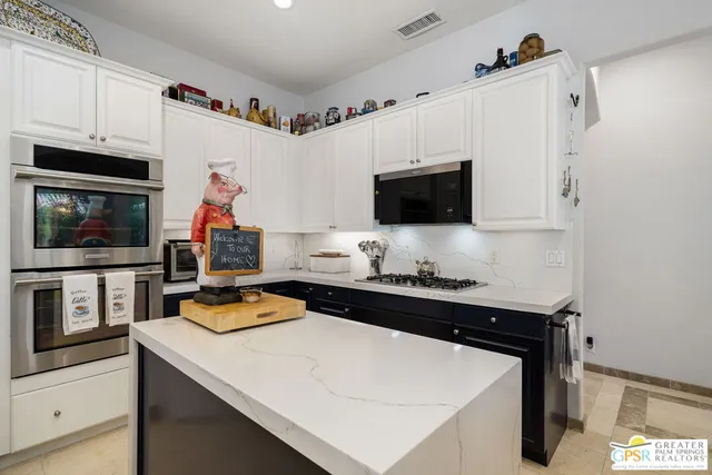 a kitchen with a sink a stove and microwave