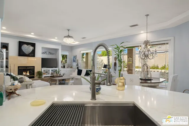 a living room with fireplace furniture and a large window