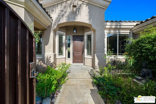 a view of a house with potted plants