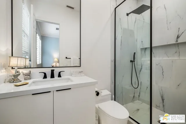 a bathroom with a sink toilet and shower