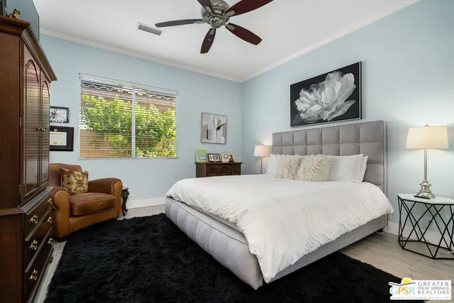 a bedroom with a bed couch and window