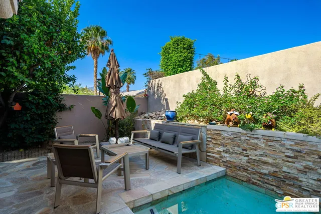 a view of a backyard with sitting area