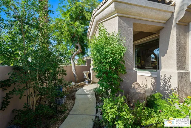 a view of a pathway both side of house