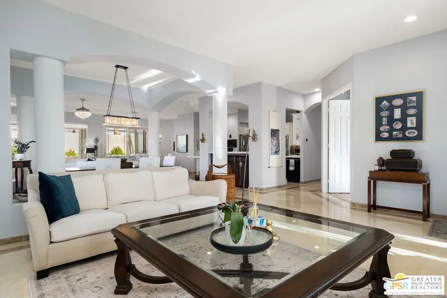 a living room with furniture and a dining table