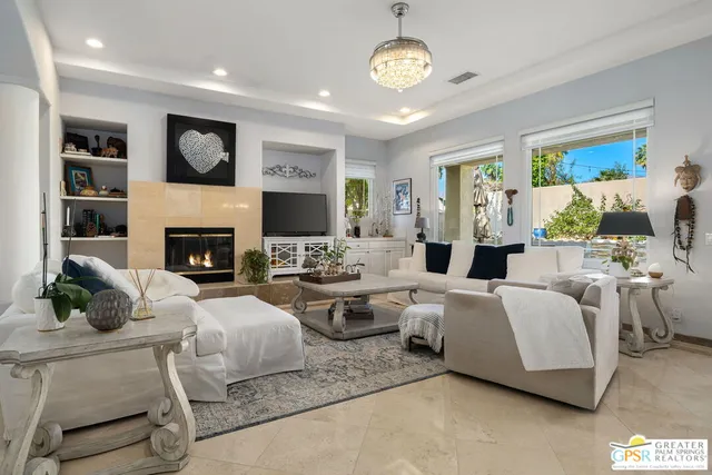 a living room with furniture flat screen tv and a fireplace