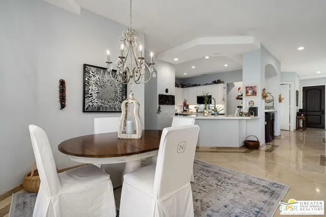 a living room with kitchen island furniture and a chandelier