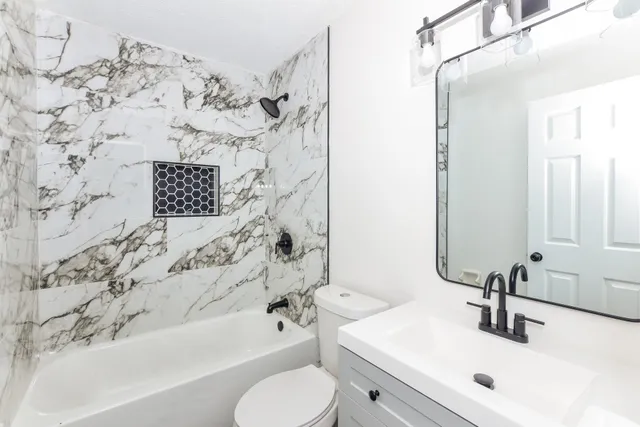 a bathroom with a sink toilet and shower