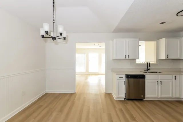 a kitchen with kitchen island a counter top space a sink and appliances