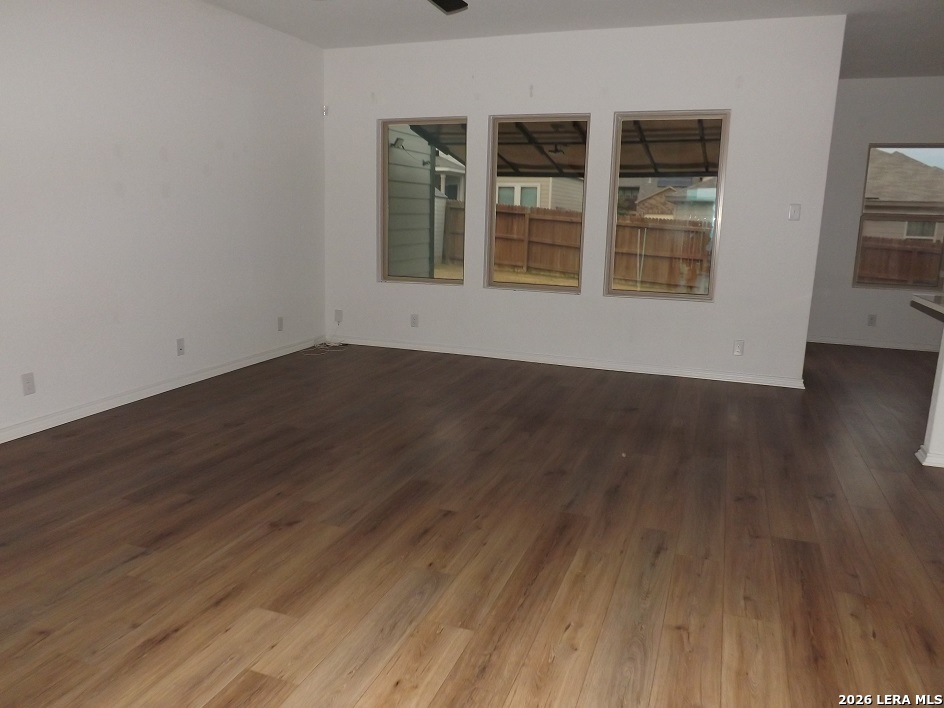 6835 Alaskan Wy. Converse, TX 78109 - Photo 17 of 22 a view of an empty room with wooden floor and windows