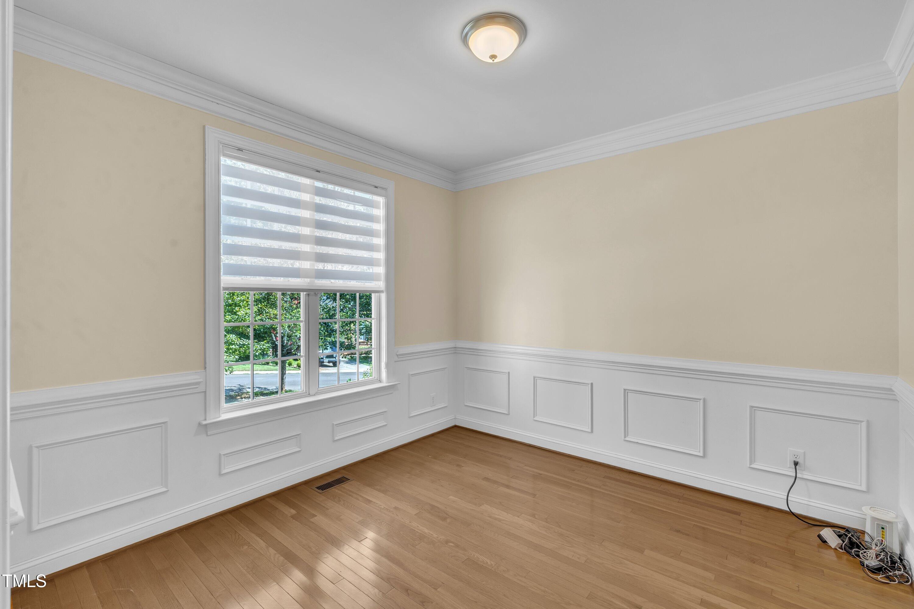 1400 Crete Drive Raleigh, NC 27606 - Photo 16 of 56 a view of an empty room with wooden floor and a window