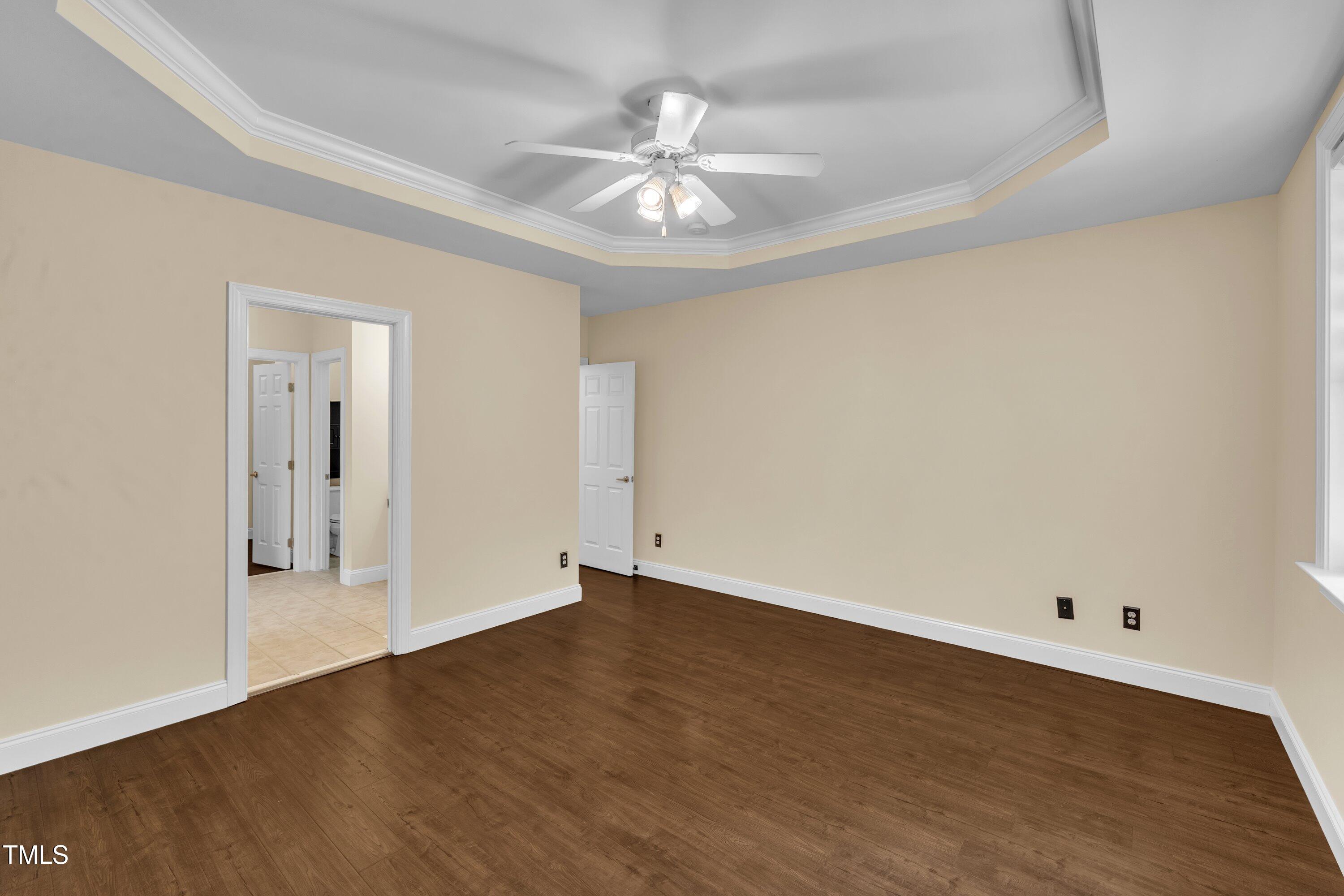 1400 Crete Drive Raleigh, NC 27606 - Photo 27 of 56 an empty room with wooden floor and ceiling fan