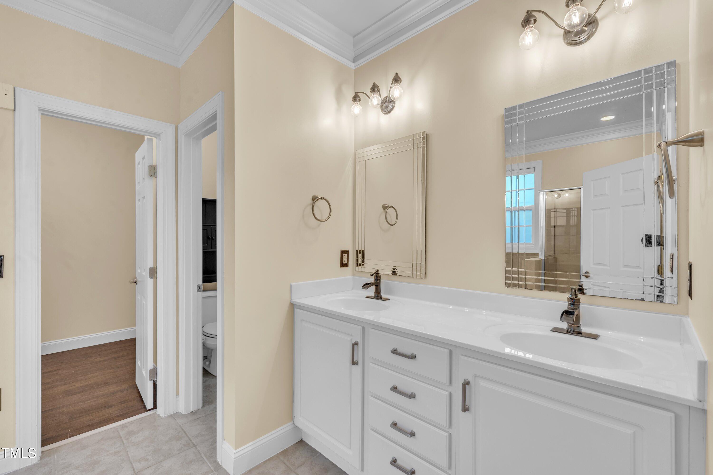 1400 Crete Drive Raleigh, NC 27606 - Photo 30 of 56 a bathroom with a double vanity sink mirror and