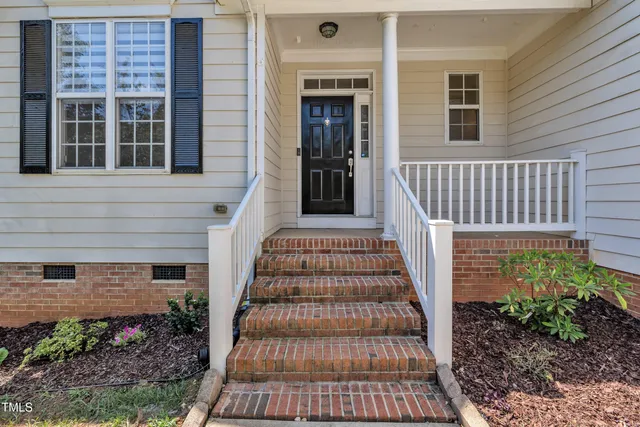 a view of a big room with wooden floor and windows