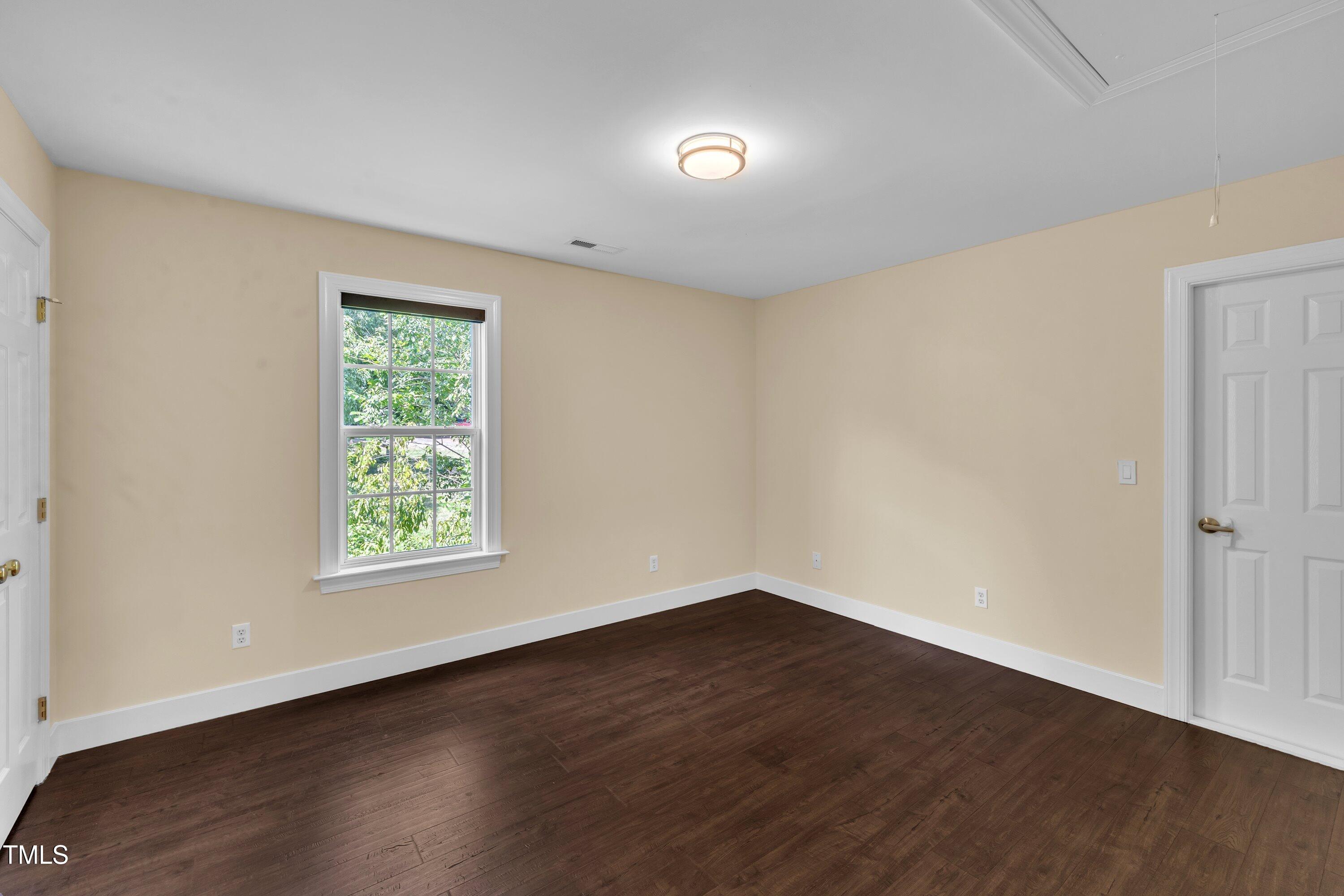 1400 Crete Drive Raleigh, NC 27606 - Photo 35 of 56 an empty room with wooden floor and windows