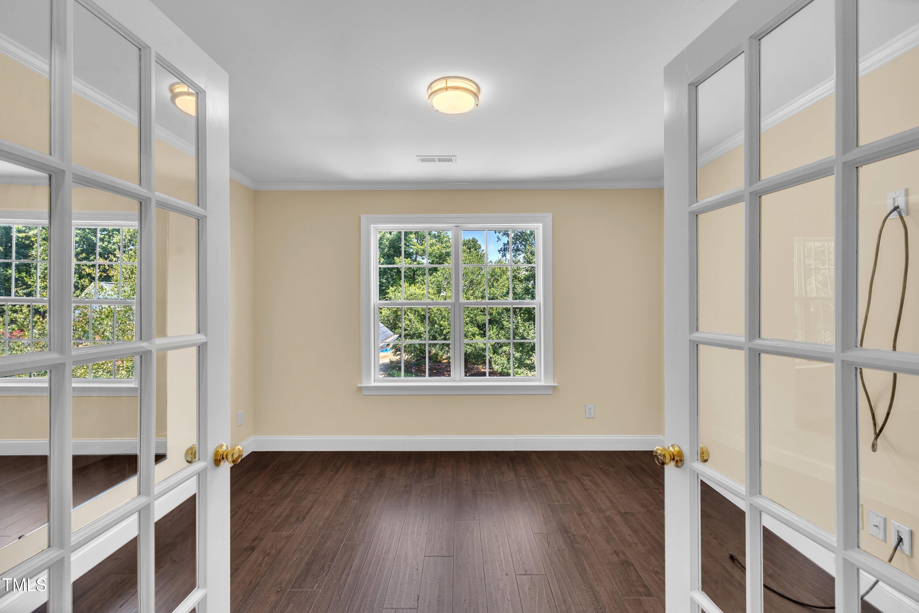 1400 Crete Drive Raleigh, NC 27606 - Photo 40 of 56 a view of an empty room with wooden floor and a window