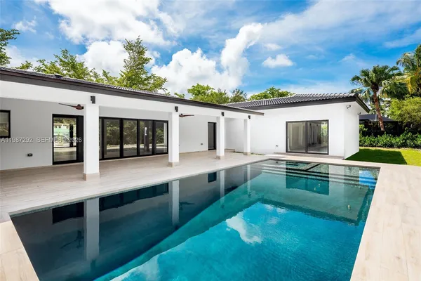 a view of a kitchen with kitchen island a sink and a wooden floor