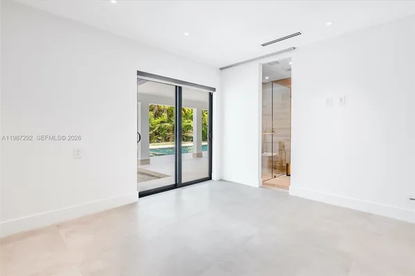 a view of an empty room with glass door