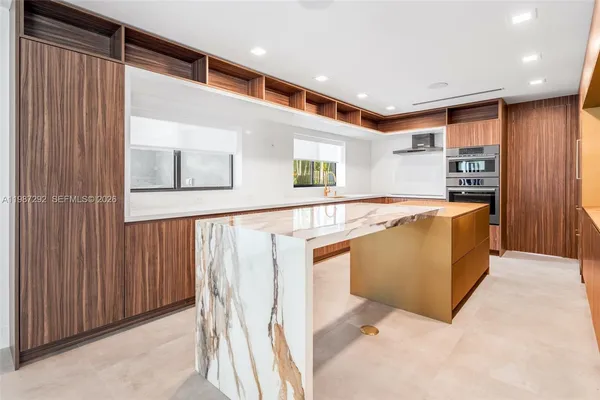a kitchen with stainless steel appliances granite countertop a refrigerator and a stove top oven