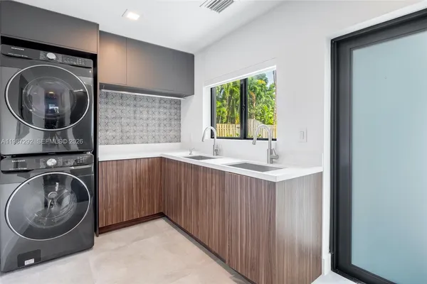 a bathroom with a sink a washer and dryer