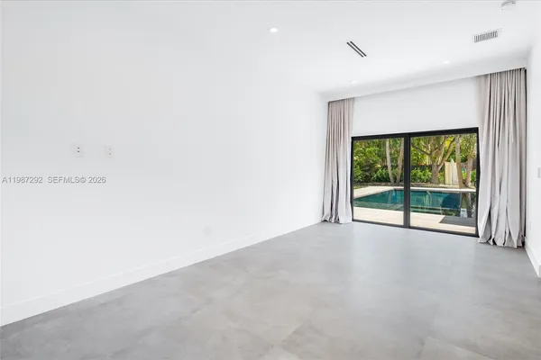a view of an empty room with a sliding door