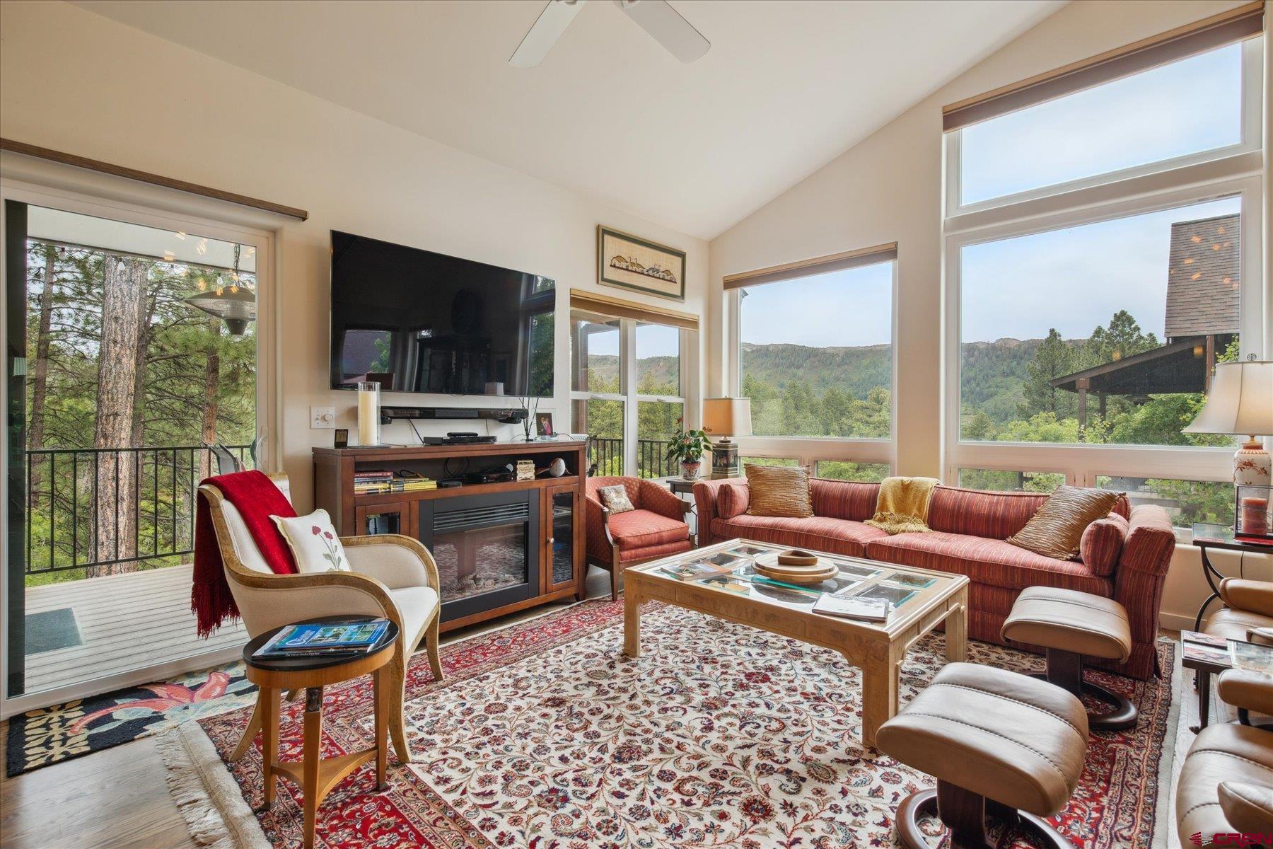 152 Red Canyon Trail, Unit R Durango, CO 81301 - Photo 12 of 42 a living room with furniture a flat screen tv and a floor to ceiling window