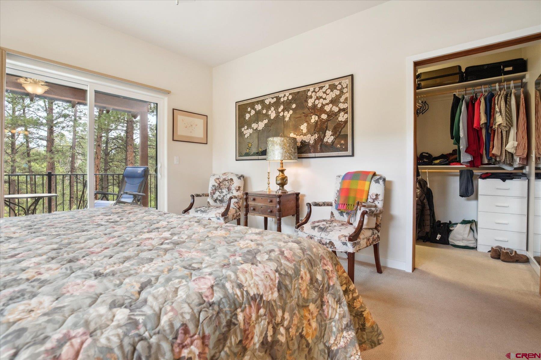 152 Red Canyon Trail, Unit R Durango, CO 81301 - Photo 18 of 42 a bed room with a bed and a large mirror