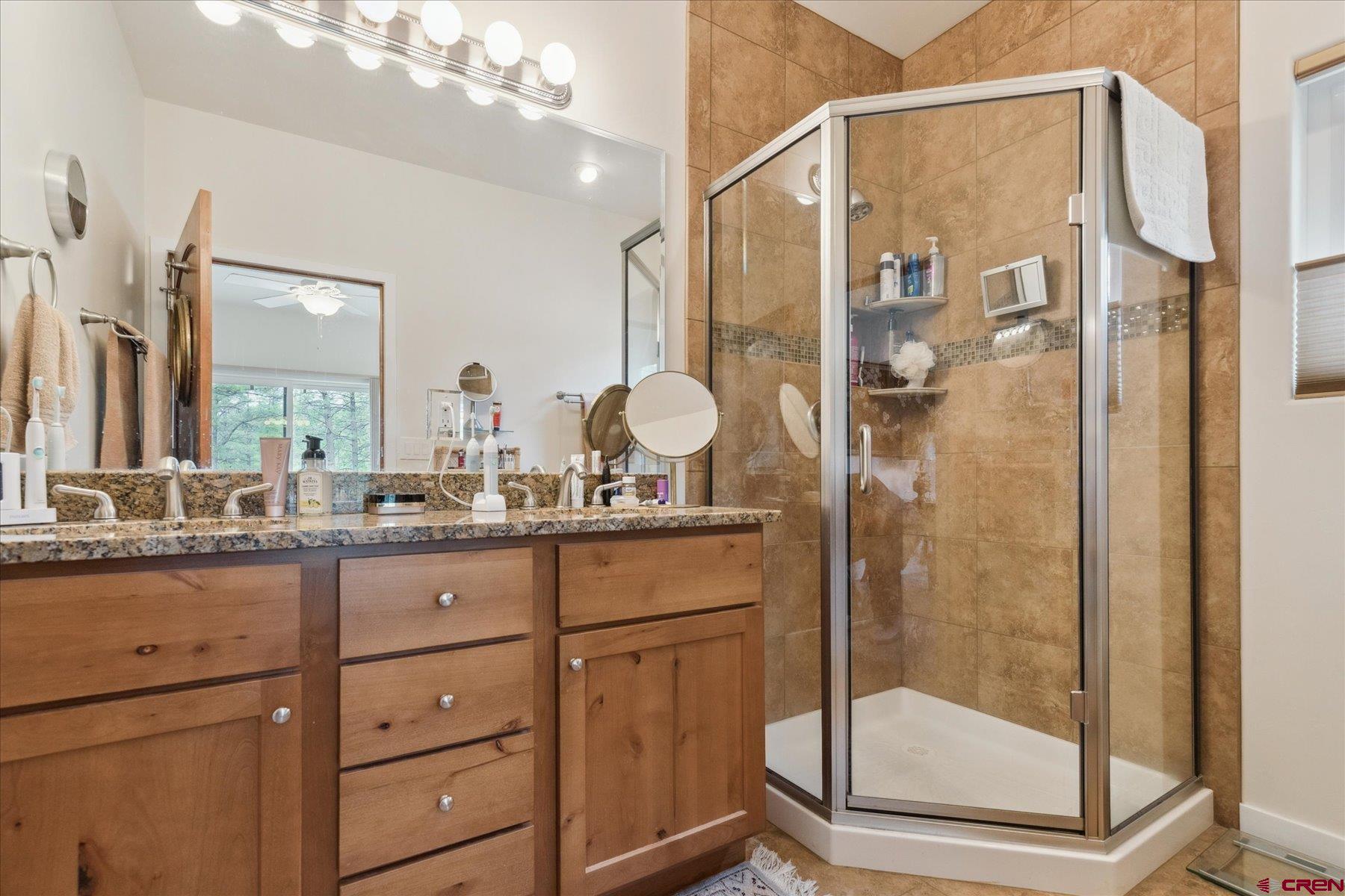 152 Red Canyon Trail, Unit R Durango, CO 81301 - Photo 20 of 42 a bathroom with a granite countertop sink mirror and shower