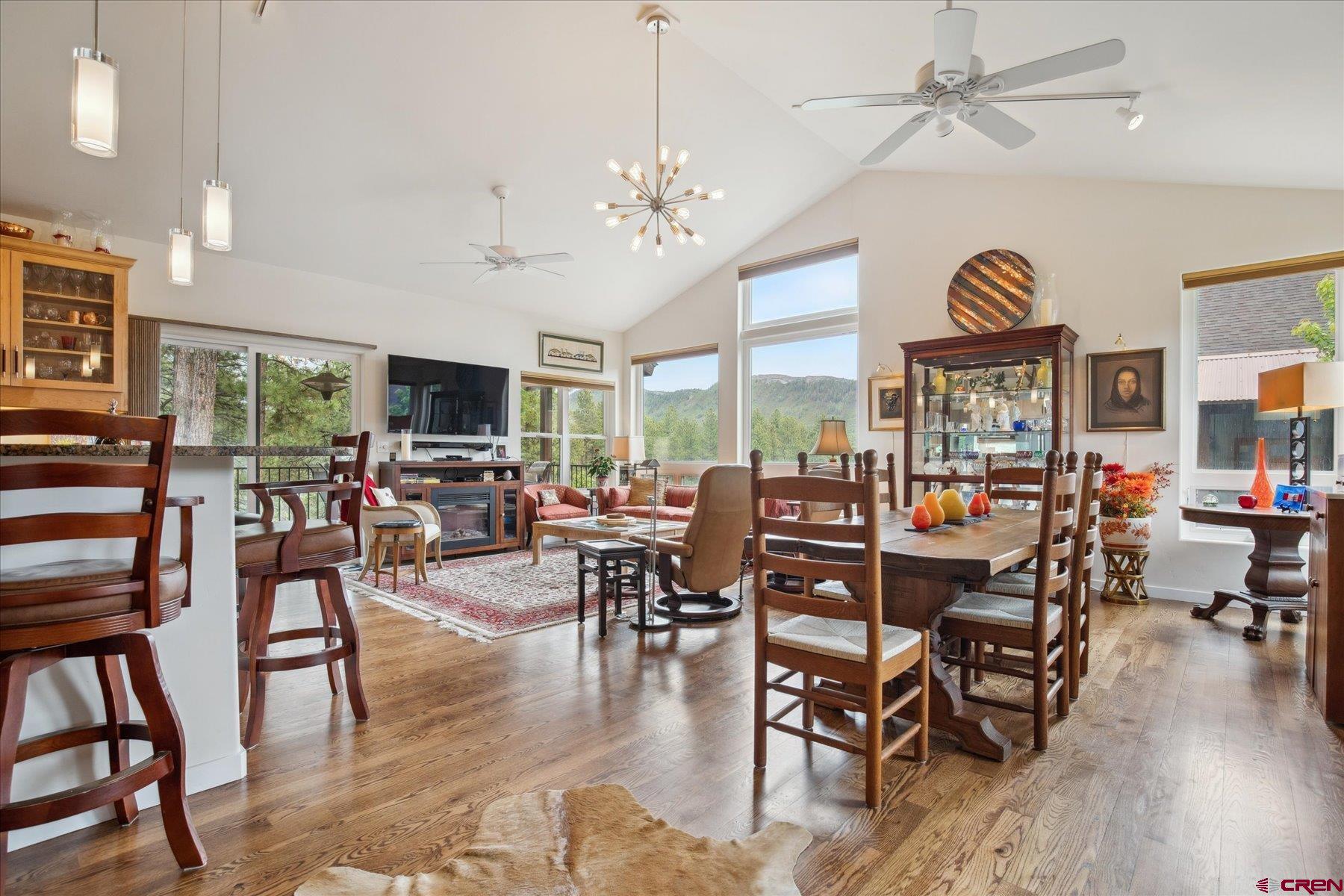 152 Red Canyon Trail, Unit R Durango, CO 81301 - Photo 2 of 42 a view of a dining room and livingroom with furniture wooden floor a chandelier