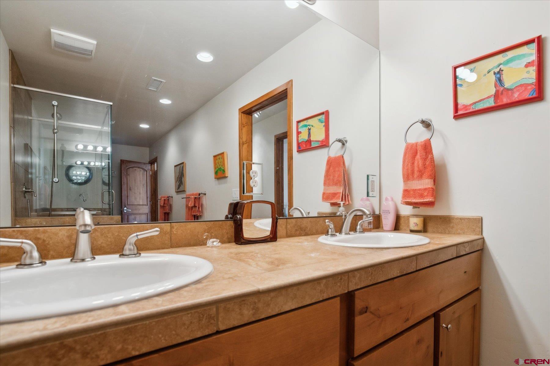 152 Red Canyon Trail, Unit R Durango, CO 81301 - Photo 30 of 42 a bathroom with double vanity sinks a shower and a mirror