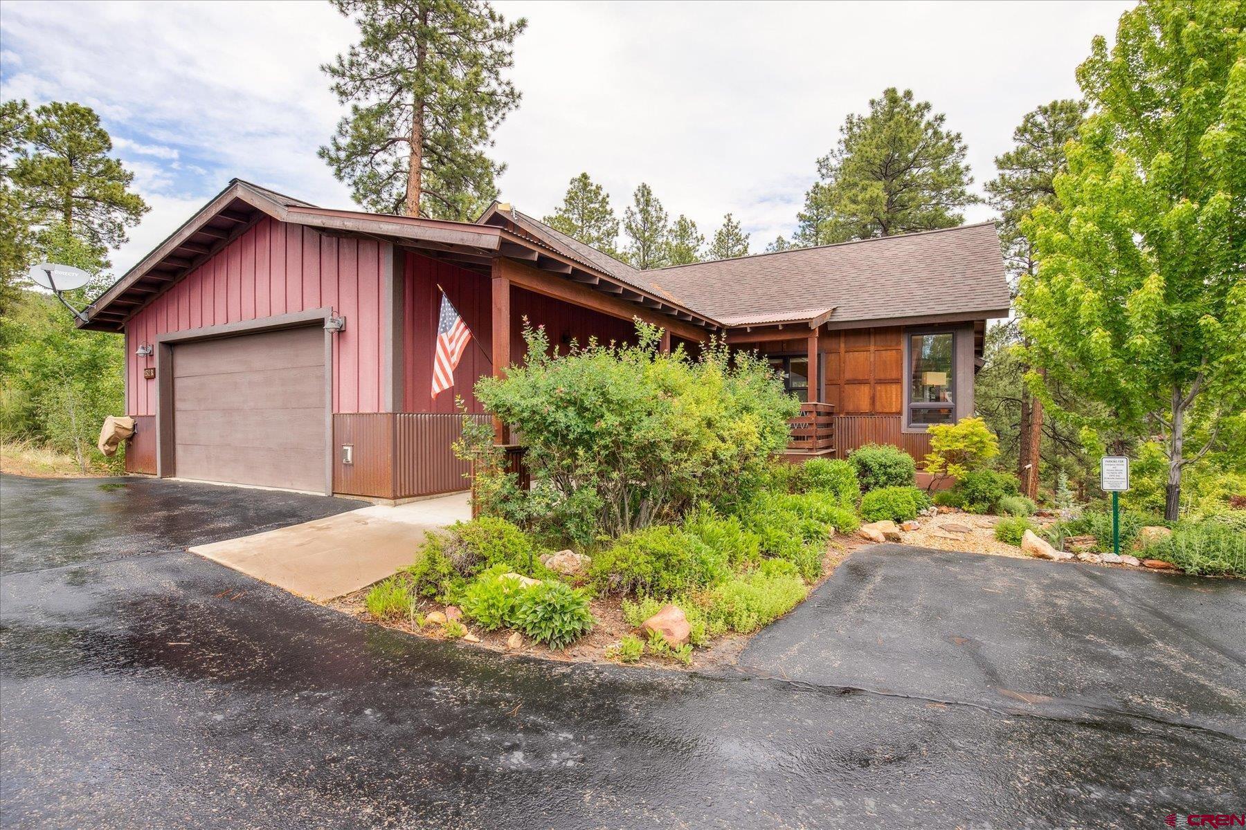 152 Red Canyon Trail, Unit R Durango, CO 81301 - Photo 36 of 42 a front view of a house with a yard and garage