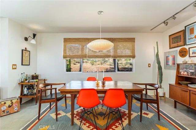 a view of a dining room with furniture and a chandelier