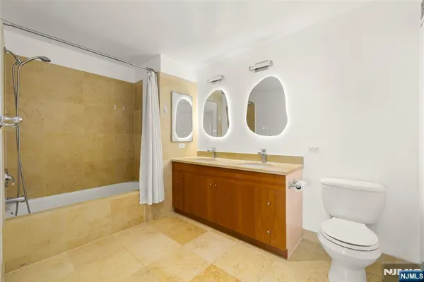 a bathroom with a toilet a sink and a shower