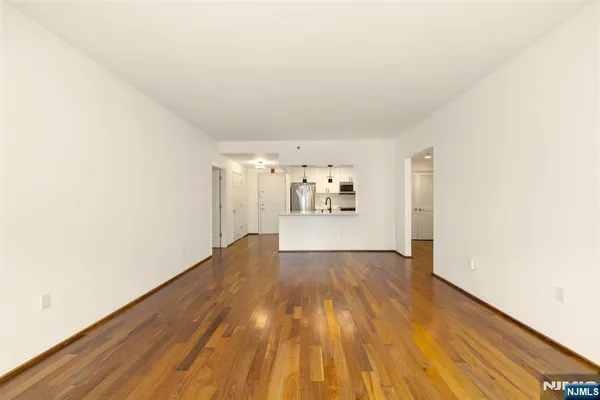 a view of a room with wooden floor