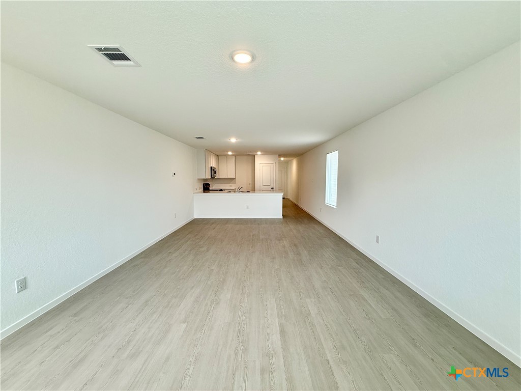413 Moscato Road New Braunfels, TX 78130 - Photo 10 of 28 a view of empty room with wooden floor and fan