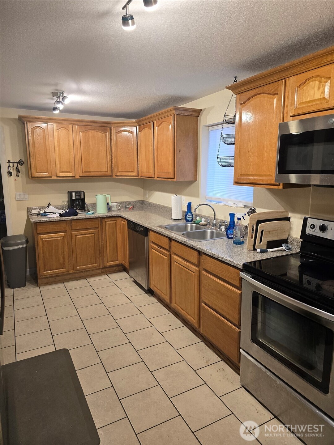 1205 Cedar Street Raymond, WA 98577 - Photo 3 of 8 a kitchen with a sink a stove and cabinets