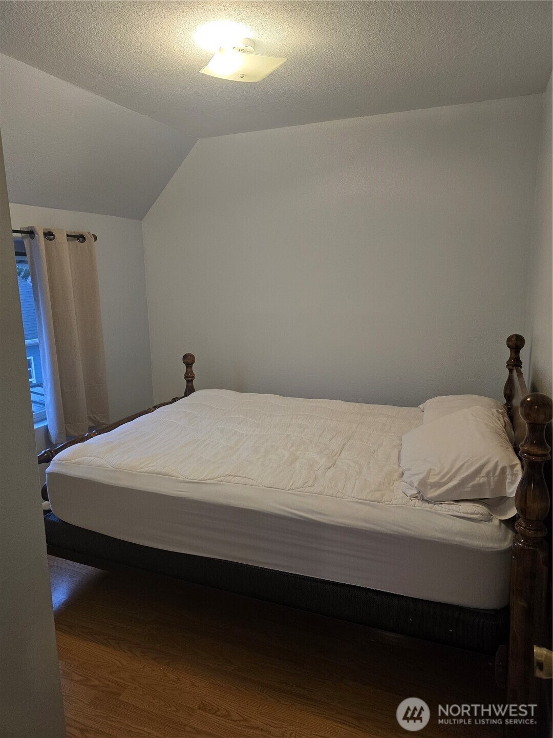 1205 Cedar Street Raymond, WA 98577 - Photo 6 of 8 a bedroom with a bed and a window