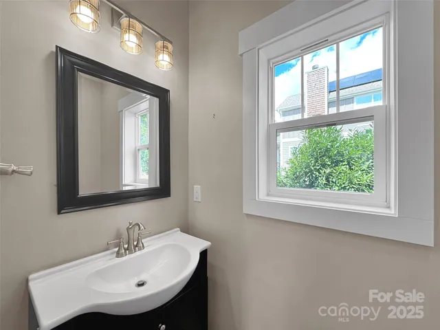 a bathroom with a sink a mirror and a window