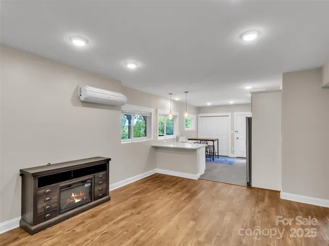 a large white kitchen with stainless steel appliances