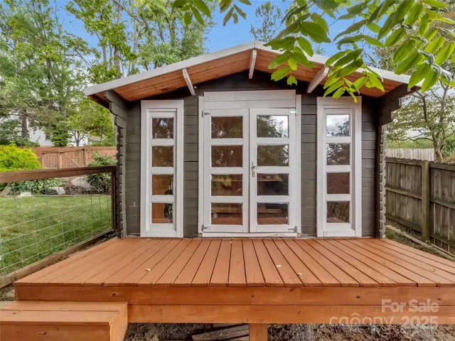a view of a yard with potted plants